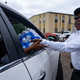 A member of Progressive Morningstar Baptist Church hands out cases of water after a Sunday morning service in Jackson, Mississippi, on September 4, 2022. - The church has reached out to various churches from across the state of Mississippi to help supply the church with bottled water to pass out to its congregation and the community as residents in Jackson continue to endure water setbacks. The city of Jackson, where 80 percent of the population is Black and poverty is rife, has experienced water crises for years. But this one is particularly severe, with many residents lacking clean running water for nearly a week.